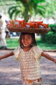 Travel photography:Little girl selling food outside Wat Phnom in Phnom Penh, Cambodia
