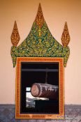 Travel photography:Temple window with large drumm near Odonk (Udong) , Cambodia