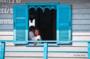 Travel photography:Girl looking out from her school`s window near Tonle Sap lake, Cambodia