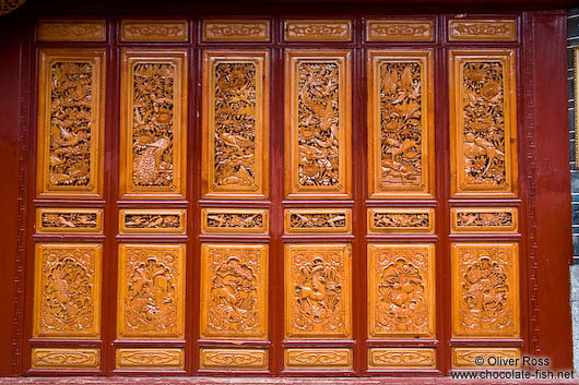 Ornately carved wooden doors in Lijiang 