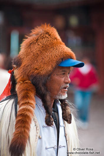 Man with fur hat in Lijiang
