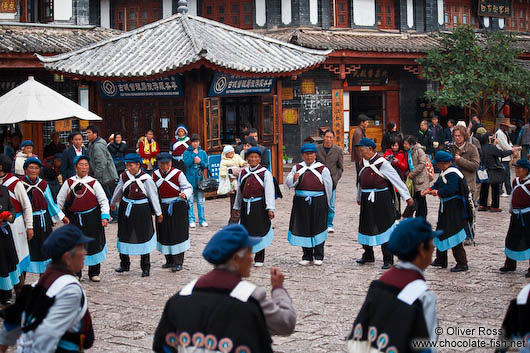 Group of Naxi women performing a traditional dance in Lijiang