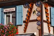 Travel photography:Gugelhupf (ring cake) baking forms on a facade in Obernai, France