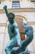 Travel photography:Sculpture of Hercules and the serpent at the Louvre museum in Paris, France