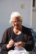 Travel photography:Woman knitting in a village near Garazo, Grece