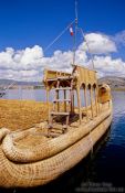 Travel photography:Uros boat docked at one of the floating reed islands in Lake Titikaka, Peru