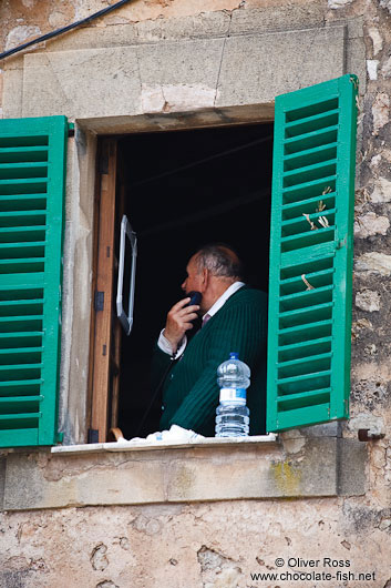 Man shaving at open window in Valldemossa village