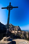 Travel photography:Giant cross on a mountain opposite the Montserrat monastery, Spain