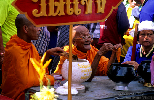 Monk blessing with water at a festival in Trang