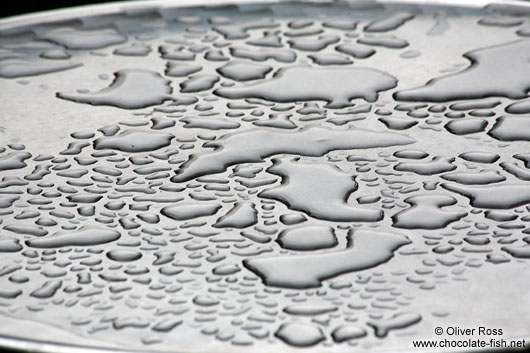 Water left on a street cafe table after a rain shower