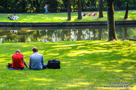 People enjoying summer in a Bruges park