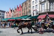 Travel photography:Horse carts carry tourists through Bruges, Belgium