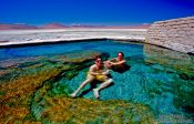 Travel photography:Tourists in a volcanic pool, Bolivia