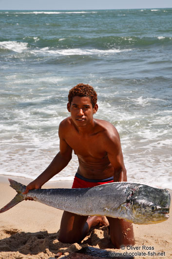 Boy with dorado fish on Boipeba Island