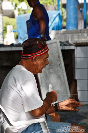 Copacabana fisherman mending his net