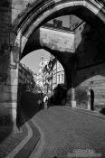 Travel photography:Leaving the Charles Bridge through the western gate, Czech Republic