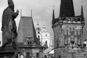 Travel photography:Skyline of the Lesser Quarter with statue viewed from Charles Bridge, Czech Republic