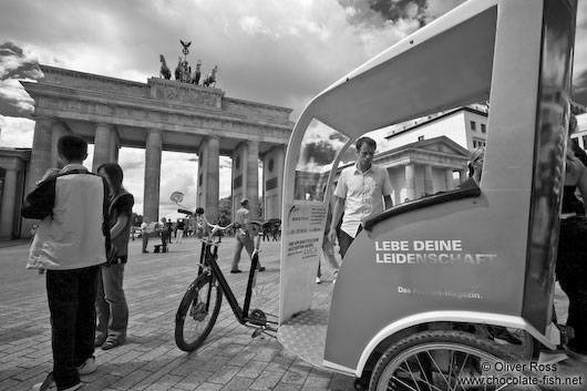 The Brandenburg Gate in Berlin with cycle rickshaw