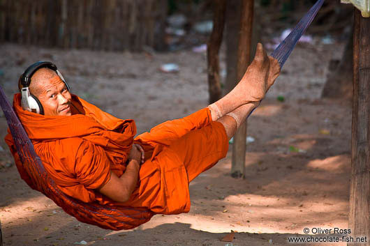 Buddhist monk with headphones near Angkor Thom