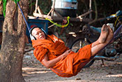 Travel photography:Buddhist monk with headphones near Angkor Thom, Cambodia