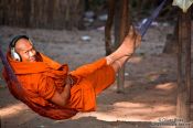 Travel photography:Buddhist monk with headphones near Angkor Thom, Cambodia