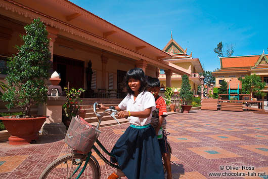 Kids on a bike at a buddhist monk school in Phnom Penh