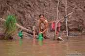 Travel photography:Washing clothes in the Mekong river , Cambodia