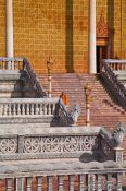 Travel photography:Monk descending a temple staircase at the Vipassara Dhara Buddhist Centre near Odonk (Udong), Cambodia