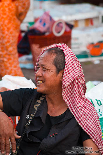 Man with Khmer head scarf at the Battambang central market people 
