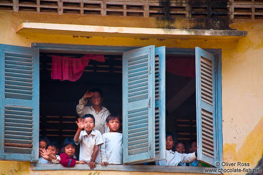 Kids waving out from their school window