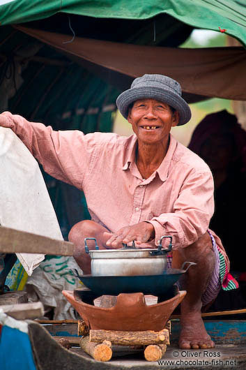 Man cooking on his boat on the Stung Sangker river