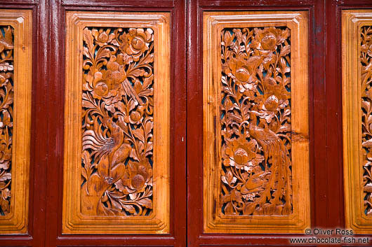 Ornate carvings on a wooden door in Dali