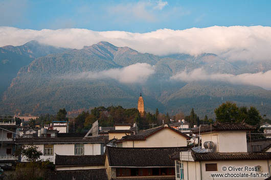 The golden Pagoda in Dali with mountains 