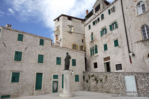 Houses in Sibenik with the bronze statue of Dalmatinac by Ivan Mestrovic