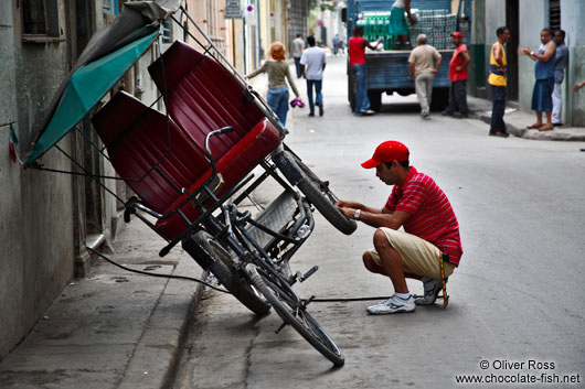 Repairing the cycle rickshaw in Havana