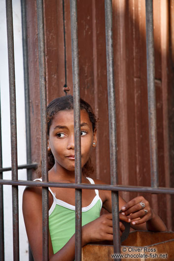 Trinidad girl behind window bars