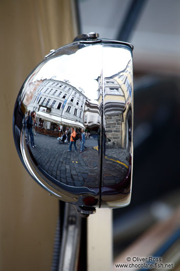 Reflections in a vintage car headlamp