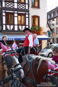 Travel photography:Man in traditional dress on a horse cart in Obernai, France