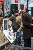 Travel photography:Passers-by browse through the art on offer in Paris´ Montmartre district, France