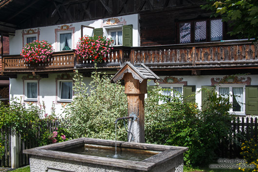 Traditional house with water fountain in Garmisch-Partenkirchen