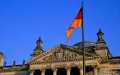 Travel photography:The Reichstag with glass cupola and flag, Germany