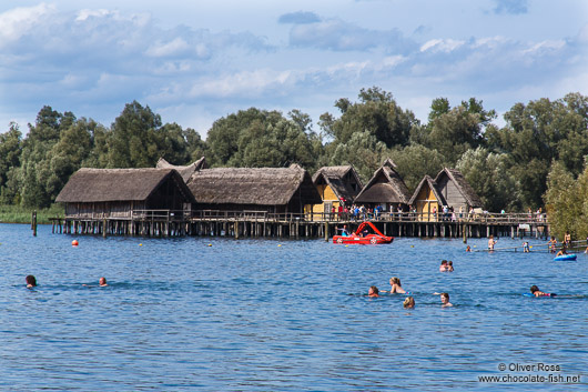 Bathers in Lake Constance near the Neolithic stilt houses in Unteruhldingen