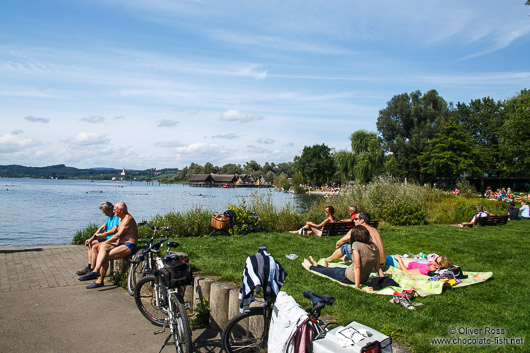 Bathers in Lake Constance near the Neolithic stilt houses in Unteruhldingen