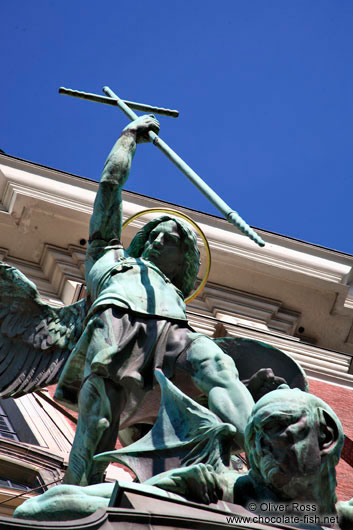 Bronze sculpture of the archangel Michael defeating the devil above the entrance portal of St. Michaelis church (Michel)