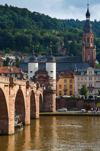 View of Heidelberg's old bridge across the Neckar River with the Holy Ghost church and old city gate