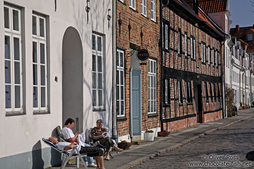 People enjoying the good weather outside their house in Lübeck