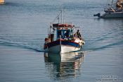 Travel photography:Returning fishing boat in Iraklio (Heraklion) harbour, Grece