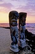 Travel photography:Two guardians at Pu`uhonua o Honaunau during sunset, Hawaii USA