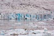 Travel photography:Edge of the Vatnajökull glacier calving into Breiðárlón lake, Iceland