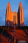 Travel photography:Light of the midnight sun on midsummer night hits the church in Akureyri, Iceland